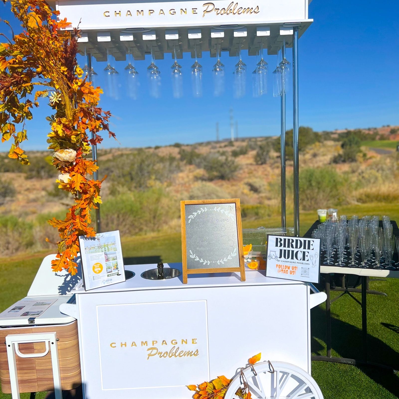 Champagne Problems mobile bar styled with autumn florals at an outdoor golf event